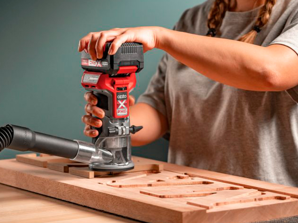 A woman is working with a sander
